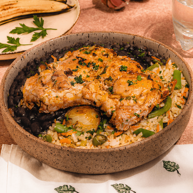 Sobrecoxa ao forno com cebola baby, arroz de legumes e feijão preto